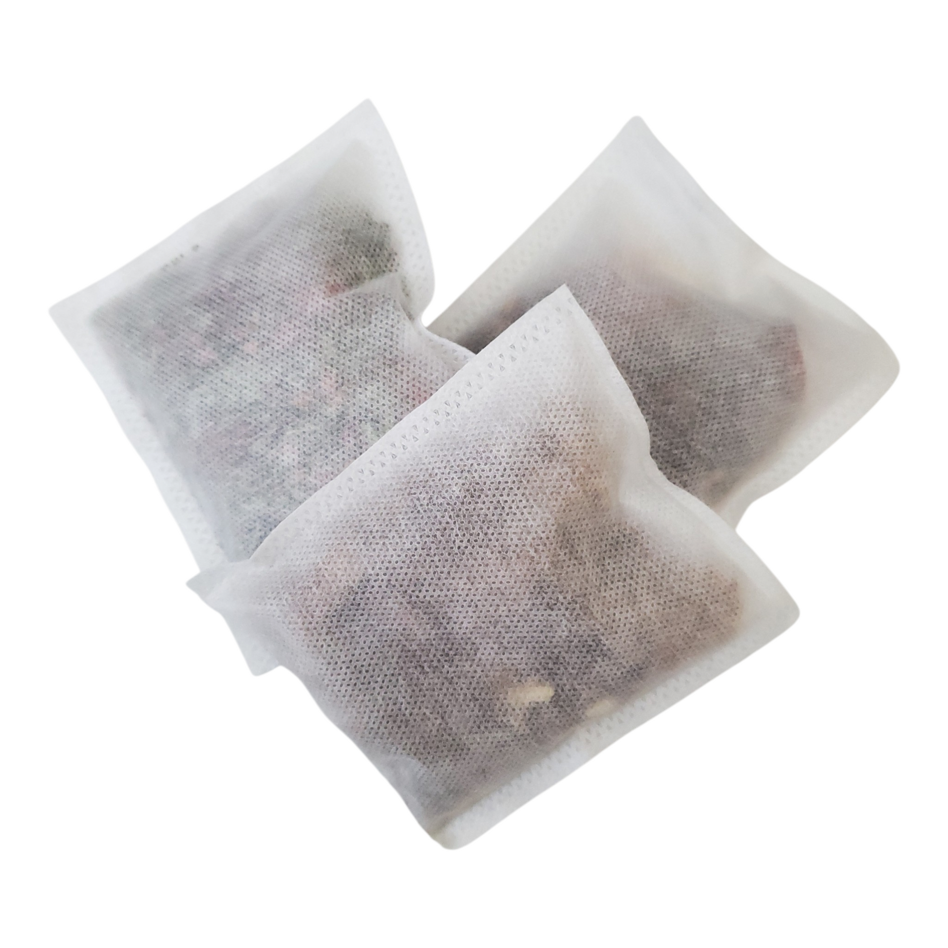 Three large square tea bags on a white background